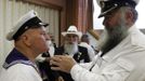 Participants help each other to get ready for the 2012 European Beard and Moustache Championships in Wittersdorf near Mulhouse, Eastern France, September 22, 2012. More than a hundred participants competed in the first European Beard and Moustache Championships organized in France. REUTERS/Vincent Kessler (FRANCE - Tags: SOCIETY) Published: Zář. 22, 2012, 7:28 odp.