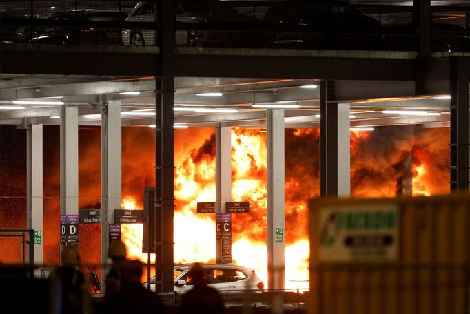 Flames are seen as emergency services respond to a fire in Terminal Car Park 2 at London Luton airport in Luton, Britain, October 10, 2023.  REUTERS/Peter Cziborra