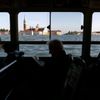 People sit on a boat in Venice