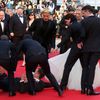 A man is arrested by security on the red carpet as actress Cate Blanchett looks on during arrivals for the screening of the film &quot;How to Train Your Dragon 2&quot; out of competition at the 67th C