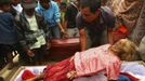 A man removes a mummy from a coffin before giving it new clothes in a ritual in the Toraja district of Indonesia's South Sulawesi Province, August 23, 2012. The ritual, called Ma'nene, involves changing the clothes every three years of mummified ancestors to honor love for the deceased. Locals believe dead family members are still with them, even if they died hundreds of years ago, a family spokesman said. Picture taken August 23, 2012. REUTERS/Yusuf Ahmad (INDONESIA - Tags: SOCIETY RELIGION) Published: Srp. 24, 2012, 1:03 odp.