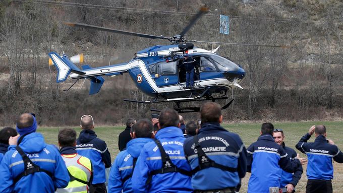 French Police and Gendarmerie Alpine rescue units gather on a field as they prepare to reach the crash site of an Airbus A320