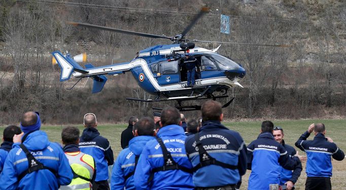 French Police and Gendarmerie Alpine rescue units gather on a field as they prepare to reach the crash site of an Airbus A320