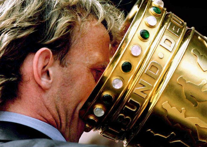 FILE PHOTO: Andreas Brehme from the German soccer cup winner FC Kaiserslautern drinks out of the cup during the victory ceremony for the Kaiserslautern soccer team in Kai