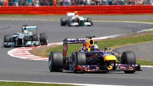 Red Bull Formula One driver Sebastian Vettel of Germany (front) takes a corner during the British Grand Prix at the Silverstone Race circuit, central England, June 30, 20