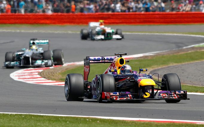 Red Bull Formula One driver Sebastian Vettel of Germany (front) takes a corner during the British Grand Prix at the Silverstone Race circuit, central England, June 30, 20