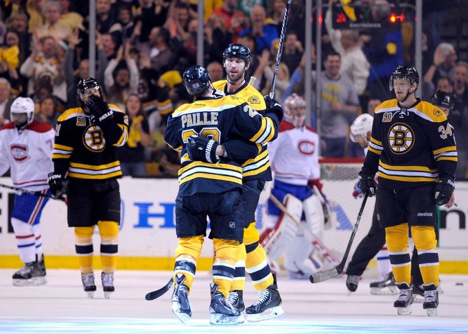 oston Bruins left wing Daniel Paille (20) is congratulated by Zdeno Chara (33) after scoring a goal during the first period against the Montreal Canadiens in game two of