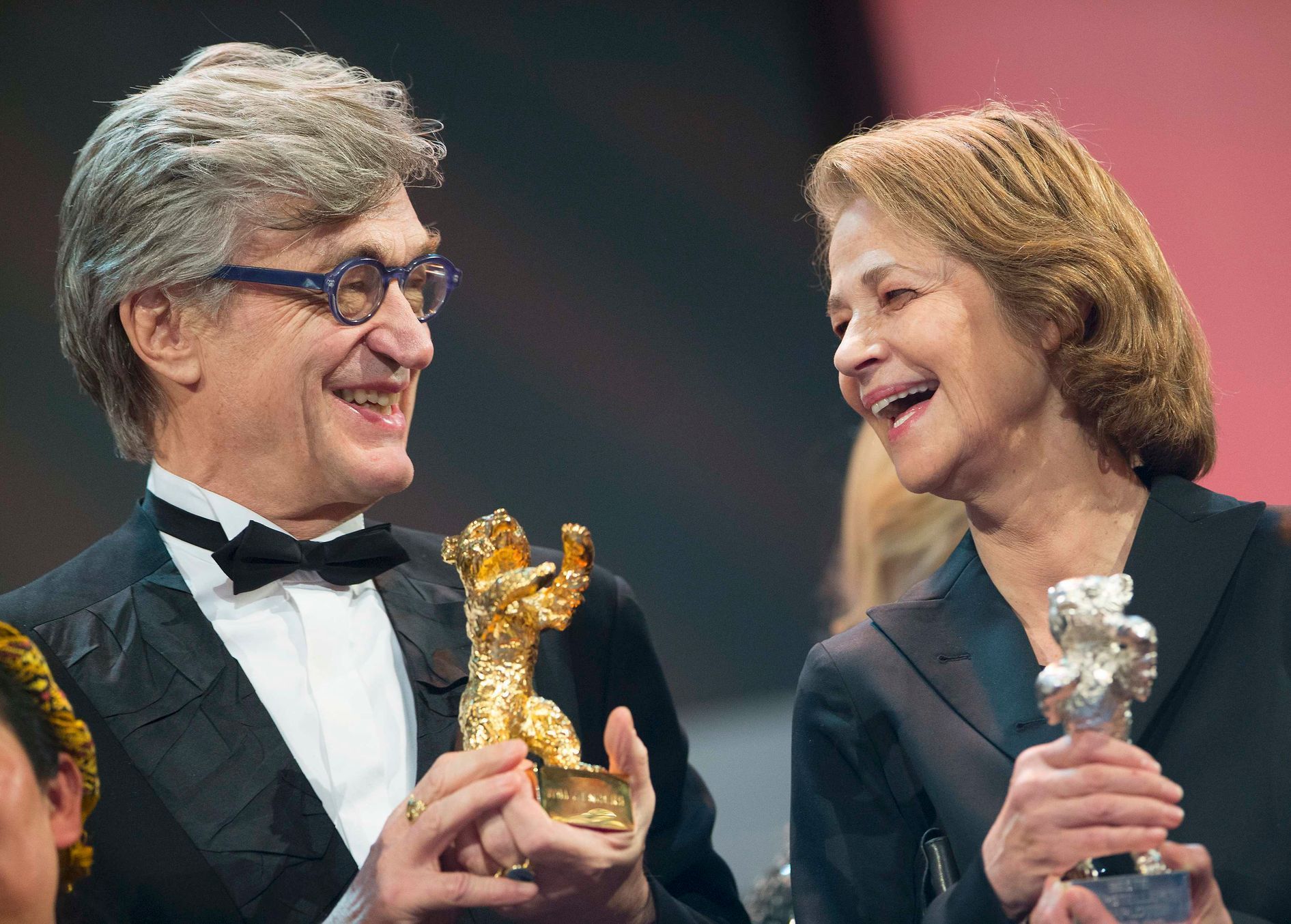 Director Wenders holds an Honorary Golden Bear next to actress Rampling holding her Silver Bear for Best Actress for the film '45 Years' at the awards ceremony of the 65th Berlinale International Film