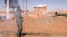 A female fighter of the Kurdish People's Protection Units (YPG) fires a Rocket-propelled grenade (RPG) as she participates in a military training