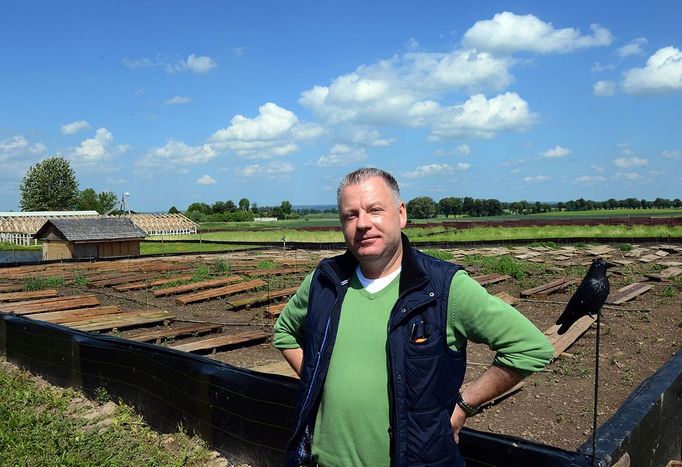 O GO WITH AFP STORY by ANNA MARIA JAKUBEK - Grzegorz Skalmowski, owner of the "Snail Garden", poses at his farm in Krasin, northern Poland, on May 29, 2013.