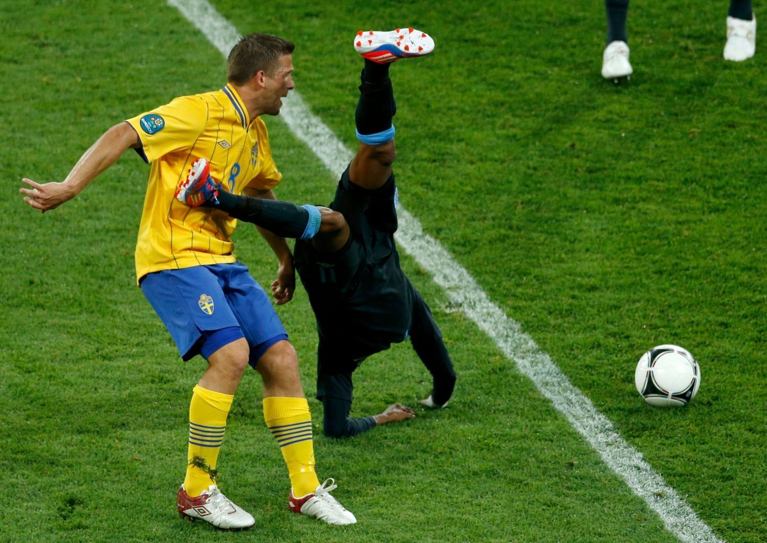 Švédský fotbalista Anders Svensson fauluje Angličana Shleyho Younga v utkání skupiny D na Euru 2012