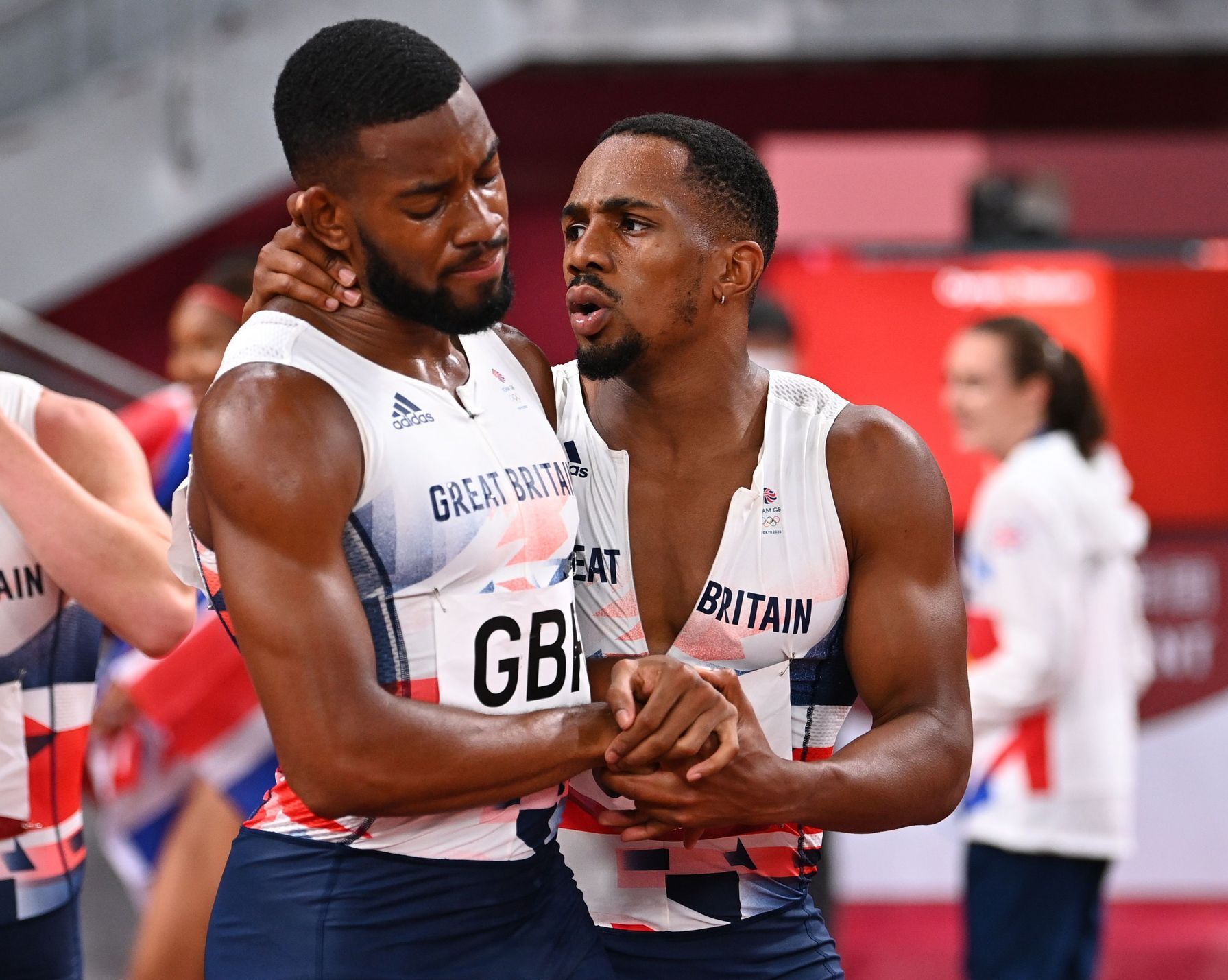 Nethaneel Mitchell-Blake of Britain is consoled by Chijindu Ujah of Britain after winning silver