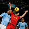 Liverpool's Suarez is challenged by Manchester City's Lescott during their English Premier League soccer match in Manchester