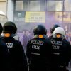 German riot police watch protestors walking during a May Day march through Berlin's Kreuzberg district,