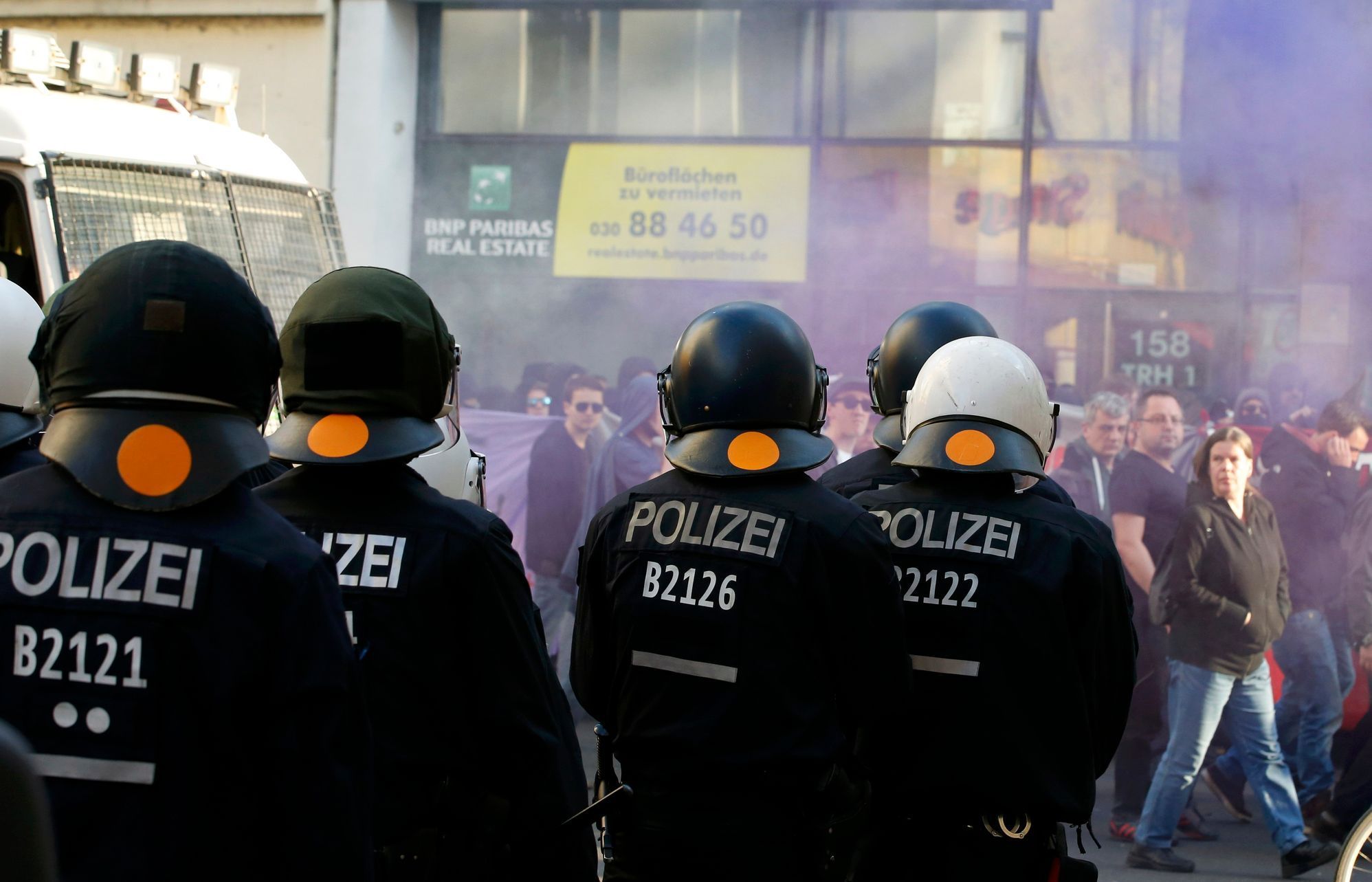 German riot police watch protestors walking during a May Day march through Berlin's Kreuzberg district,