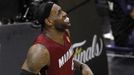 Miami Heat's LeBron James grimaces after hurting his leg during the fourth quarter against the San Antonio Spurs in Game 1 of their NBA Finals basketball series in San An