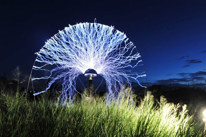 Performing With Lightning CHANGLE, CHINA - AUGUST 12: (CHINA OUT) A guitarist plays guitar as high voltage of up to 1 million volts, generated by a Tesla coil transformer, runs through his body during a stunt performance on August 12, 2012 in Changle, Fujian Province of China. Wang Zengxiang, one of the craziest fans of the Tesla coil stunt, has dedicated himself in the daredevil career for a decade. He is now the leader of a band of four. A Tesla coil is an electrical resonant transformer circuit invented by Nikola Tesla around 1891. The transformer produces high voltage at high frequencies, which acts as a giant lightning machine, and creates long bolts of electricity. Shielded by protective clothing, the performer is insulated from the electricity current which dissipates through the ground