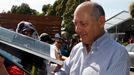 Chairman and CEO of McLaren Formula One team Ron Dennis signs autographs at the first practice session of the Australian F1 Grand Prix at the Albert Park circuit in Melbo