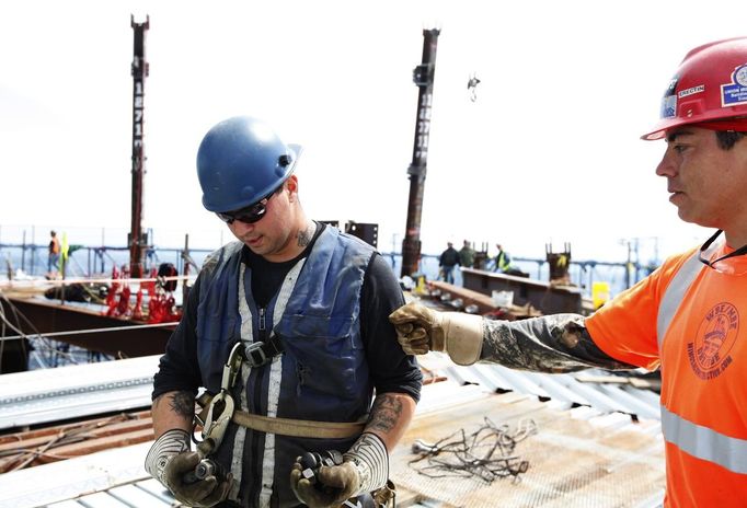 Iron workers Steven Cross (R) and Adam Cross talk after placing iron columns on the 100th story of One World Trade Center in New York, April 30, 2012. The addition of iron columns to the 100th story pushed the height of One World Trade above that of the Empire State Building today. REUTERS/Lucas Jackson (UNITED STATES - Tags: CITYSPACE SOCIETY BUSINESS CONSTRUCTION) Published: Dub. 30, 2012, 11:47 odp.