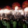 People watch fireworks exploding over Copacabana beach during New Year celebrations at the Pavao Pavaozinho slum in Rio de Janeiro