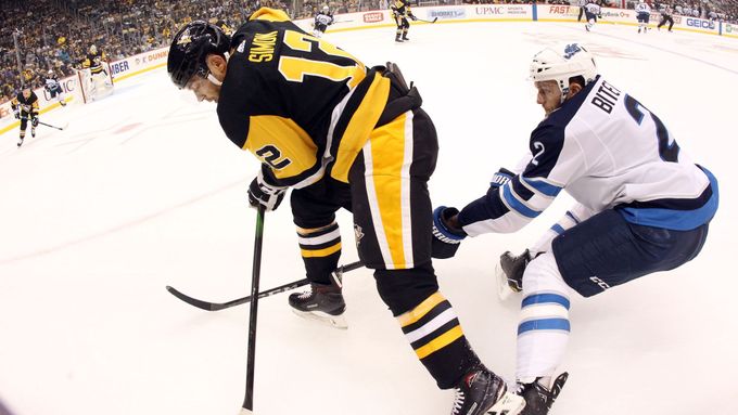 Oct 8, 2019; Pittsburgh, PA, USA; Pittsburgh Penguins center Dominik Simon (12) moves the puck against defended by Winnipeg Jets defenseman Anthony Bitetto (2) during the