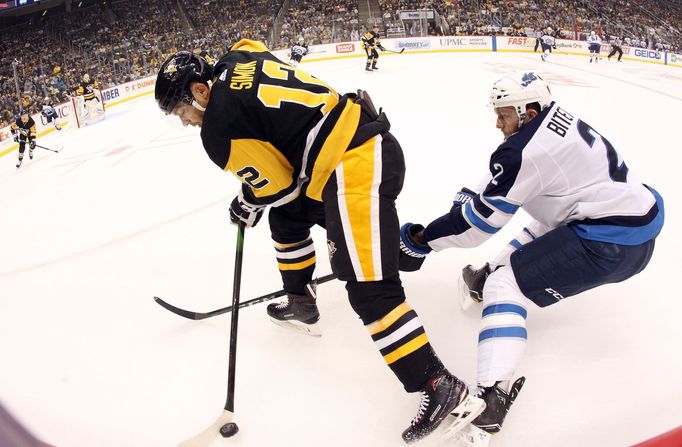 Oct 8, 2019; Pittsburgh, PA, USA; Pittsburgh Penguins center Dominik Simon (12) moves the puck against defended by Winnipeg Jets defenseman Anthony Bitetto (2) during the