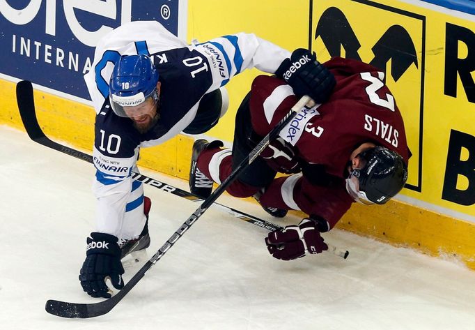 Latvia's Juris Stals (R) and Finland's Jere Karalahti (L) fall after a collision during the second period of their men's ice hockey World Championship group B game at Min