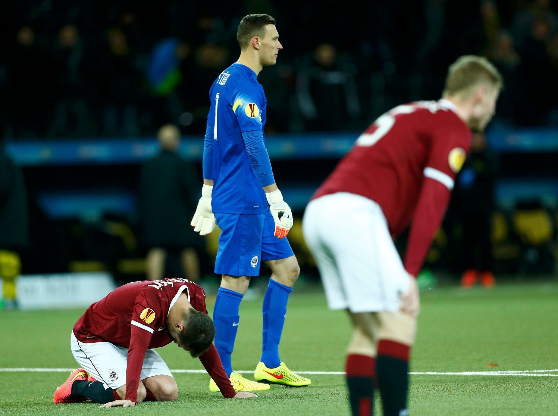 Sparta Prague players stand dejected after BSC Young Boys scored a second goal during Europa League match in Bern