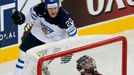 Finland's Miikka Salomaki (top) celebrates his goal as Latvia's goalie Edgars Masalskis reacts during their men's ice hockey World Championship group B game at Minsk Aren