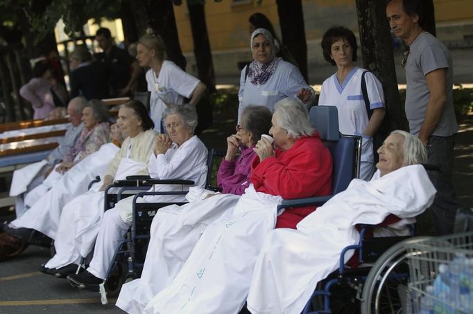 People wait outside hospital after an earthquake in Crevalcore near Modena