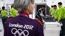 Indian shooting team member Sanjeev Rajput holds his laptop as he goes through a security check at the Welcome Center near the Athletes' Village at the Olympic Park in London July 18, 2012. REUTERS/Jae C. Hong/Pool (BRITAIN - Tags: SPORT OLYMPICS SHOOTING) Published: Čec. 18, 2012, 6:47 odp.