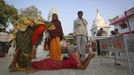 A devotee, believed to be possessed by evil spirits, goes into a state of trance as she lies in the courtyard of Guru Deoji Maharaj temple during a ghost fair at Malajpur village in Betul district in the central Indian state of Madhya Pradesh January 26, 2013. People from across India come to this fair to be exorcised of �evil spirits�. They are usually brought by relatives and they are most often women. The exorcism involves running around the temple courtyard to make the 'ghost' weak then being beaten by a priest with a broom. Picture taken January 26, 2013. REUTERS/Danish Siddiqui (INDIA - Tags: SOCIETY RELIGION) ATTENTION EDITORS: PICTURE 6 OF 24 FOR PACKAGE 'INDIAN GHOSTBUSTERS' SEARCH 'INDIA GHOST' FOR ALL IMAGES Published: Úno. 5, 2013, 5:09 dop.