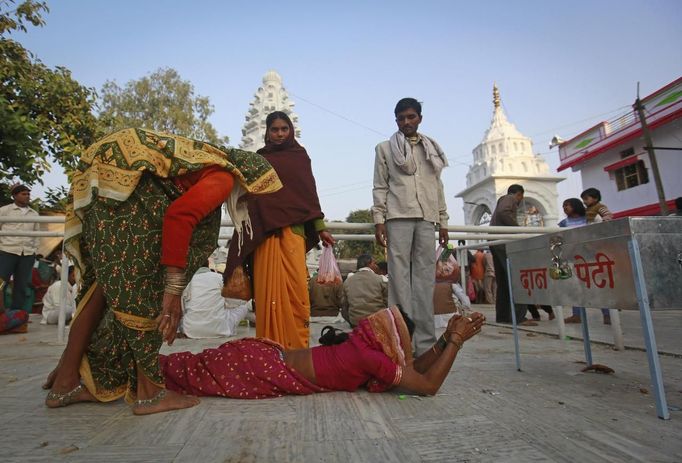 A devotee, believed to be possessed by evil spirits, goes into a state of trance as she lies in the courtyard of Guru Deoji Maharaj temple during a ghost fair at Malajpur village in Betul district in the central Indian state of Madhya Pradesh January 26, 2013. People from across India come to this fair to be exorcised of �evil spirits�. They are usually brought by relatives and they are most often women. The exorcism involves running around the temple courtyard to make the 'ghost' weak then being beaten by a priest with a broom. Picture taken January 26, 2013. REUTERS/Danish Siddiqui (INDIA - Tags: SOCIETY RELIGION) ATTENTION EDITORS: PICTURE 6 OF 24 FOR PACKAGE 'INDIAN GHOSTBUSTERS' SEARCH 'INDIA GHOST' FOR ALL IMAGES Published: Úno. 5, 2013, 5:09 dop.