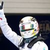 Mercedes Formula One driver Lewis Hamilton of Britain waves as he celebrates taking pole position after the qualifying session for the Chinese F1 Grand Prix at the Shanghai International circuit
