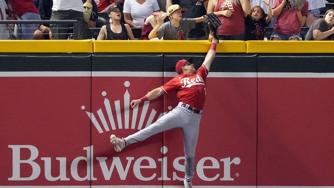 Aug 25, 2023; Phoenix, Arizona, USA; Cincinnati Reds left fielder Spencer Steer (7) is unable to make a catch on a ball hit by Arizona Diamondbacks left fielder Tommy Pha