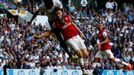 Tottenham Hotspur's Adebayor gets above Arsenal's Koscielny to head at goal during their English Premier League soccer match in London