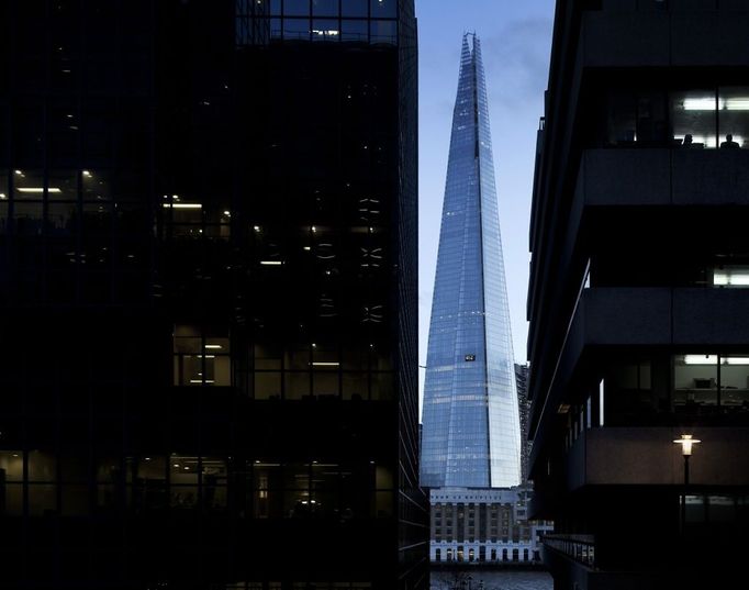 The Shard, London, United Kingdom. Architect: RENZO PIANO , 2012. Square view framed by offices from north bank of thames at dusk.