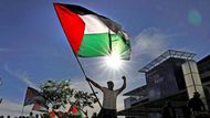 Muž s palestinskou vlajkou slaví uzavření dohody mezi Izraelem a Palestinci, kterou přivítali podporovatelé Palestinců po celém světě. Na snímku demonstrace v jihoafrickém Kapském Městě.