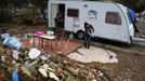 Saray Armendia uses a broom to sweep outside her caravan after a bulldozer demolished the former school, where her in-laws lived at, at the Spanish gypsy settlement of Puerta de Hierro, in the outskirts of Madrid November 20, 2012. Fifty-four families have been living in Puerta de Hierro, on the banks of the Manzanares river for over 50 years. Since the summer of 2010, the community has been subject to evictions on the grounds that the dwellings are illegal. Families, whose homes have been demolished, move in with relatives whose houses still remain while the debris keeps piling up around them as more demolitions take place. REUTERS/Susana Vera (SPAIN - Tags: CIVIL UNREST BUSINESS CONSTRUCTION) Published: Lis. 20, 2012, 4:50 odp.