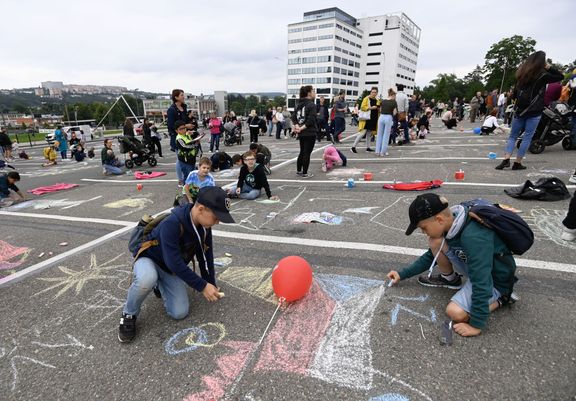 Children paint on the sidewalk in front of the Velký cinema in Zlín.  Painting was part of this year's festival.