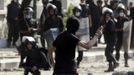 A protester throws a stone towards riot police, during clashes along a road which leads to the U.S. embassy, near Tahrir Square in Cairo September 13, 2012.