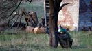 An Ukrainian soldier aim his rifle and takes cover behind a tree as pro-Russia protesters gathered in front of a Ukrainian airbase in Kramatorsk, 15. 4. 2014