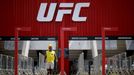 FILE PHOTO: A man walks in front of the Nilson Nelson Gymnasium as the next UFC Fight Night will be held without fans during the fights, after reports of the coronavirus