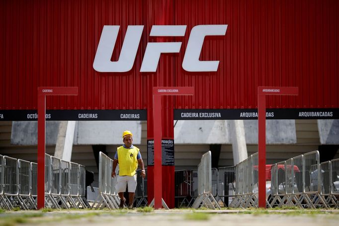 FILE PHOTO: A man walks in front of the Nilson Nelson Gymnasium as the next UFC Fight Night will be held without fans during the fights, after reports of the coronavirus