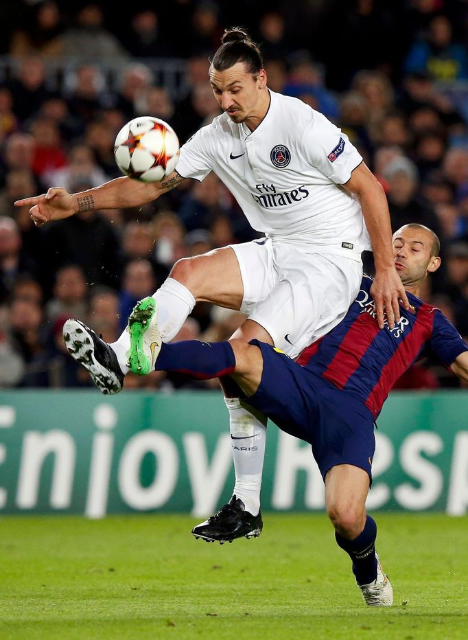 Paris St Germain's Zlatan Ibrahimovic is challenged by Barcelona's Javier Mascherano during their Champions League Group F soccer match at the Nou Camp stadium in Barcelo