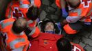 A runner, identified by a Navarran government spokesperson as a 21-year-old Japanese man from Ikeda, is attended by emergency services following the first running of the bulls in Pamplona July 7, 2012. One person was gored and four others injured in a run that lasted two minutes and fifty-two seconds, according to local media. REUTERS/Vincent West (SPAIN - Tags: ANIMALS SOCIETY) Published: Čec. 7, 2012, 9:45 dop.