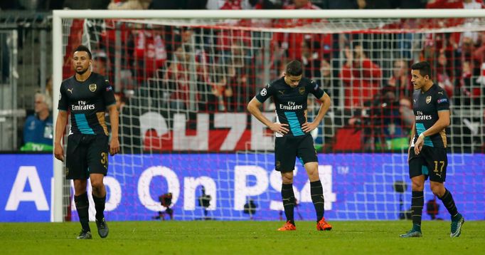 Arsenal's Francis Coquelin, Gabriel Paulista and Alexis Sanchez look dejected after David Alaba scored the third goal for Bayern Munich