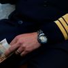 A pilot of German air carrier Lufthansa holds a 50 euro bank note as he waits for his bill in a coffee bar at the Fraport airport in Frankfurt