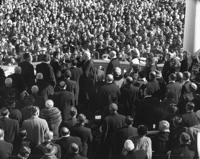 Former U.S. Supreme Court Chief Justice Earl Warren (C) administers the oath of office to former President John F. Kennedy (center-left) during inauguration ceremonies at the Capitol in Washington, in this handout photograph taken on January 20, 1961.