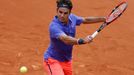 Roger Federer of Switzerland plays a shot to Alejandro Falla of Colombia during their men's singles match at the French Open tennis tournament at the Roland Garros stadiu